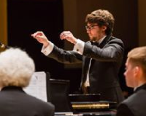 Elijah Botkin, Music Director of Revels, conducting small ensembles in chamber works.